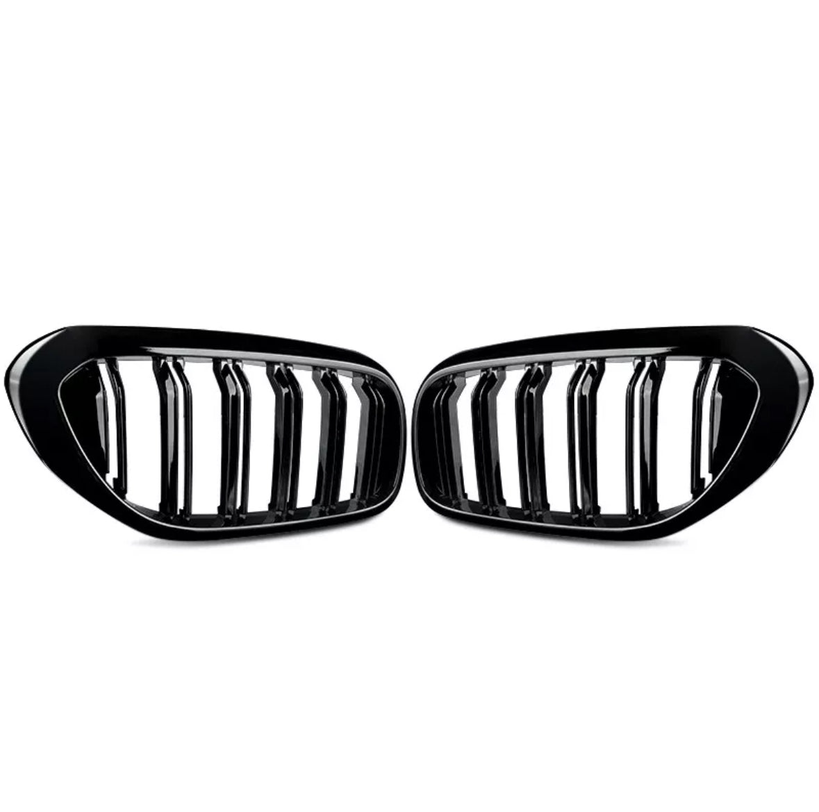 Two black car grille inserts with vertical slats are positioned symmetrically. They rest against a plain white background, showing a sleek, glossy finish.