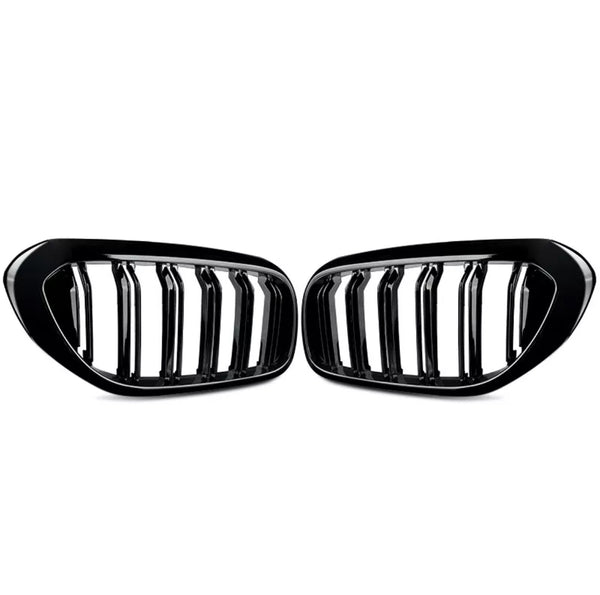 Two black car grille inserts with vertical slats are positioned symmetrically. They rest against a plain white background, showing a sleek, glossy finish.