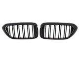 Two black, oval car grilles with vertical bars sit side by side against a white background, indicating they are designed for a vehicle's front end.