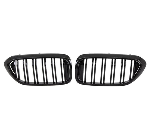 Two black, oval car grilles with vertical bars sit side by side against a white background, indicating they are designed for a vehicle's front end.