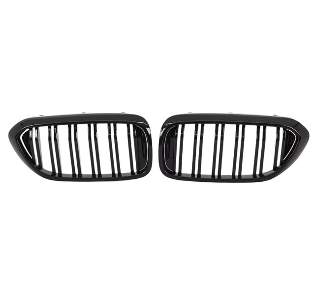 Two black, oval car grilles with vertical bars sit side by side against a white background, indicating they are designed for a vehicle's front end.