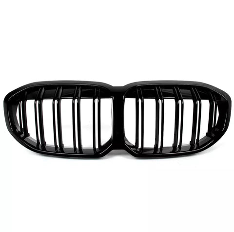 Black car grille with vertical slats, designed in a double kidney shape, isolated on a white background.