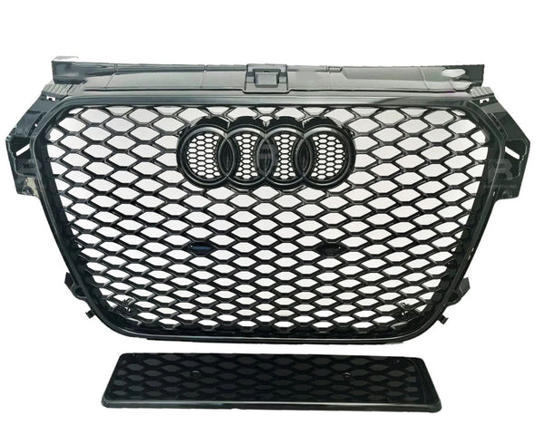 A black car grille with a honeycomb pattern featuring four interlinked rings at the center. It is positioned against a plain white background.