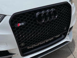 Car grille with black honeycomb design features the Audi rings, an 