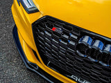 A yellow Audi S8 is parked on asphalt, featuring a prominent black grille with a red 