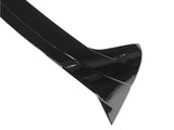 A glossy, black, aerodynamic car spoiler is displayed. It is angled and curved for minimizing drag, set against a plain white background, highlighting its sleek design.