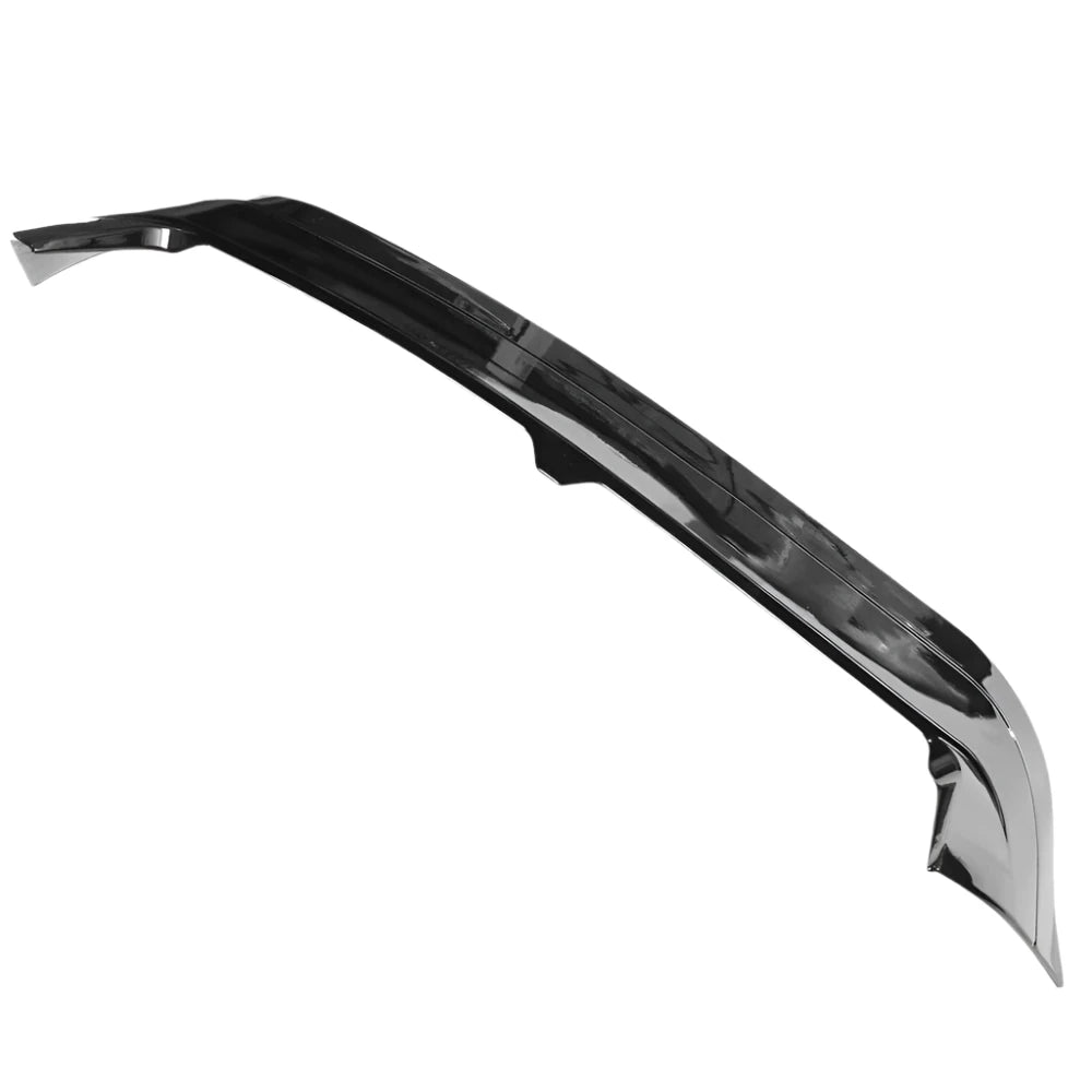 A glossy black car spoiler arcs upwards, displaying aerodynamic contours. It is positioned against a plain white background, highlighting its sleek design and polished surface.