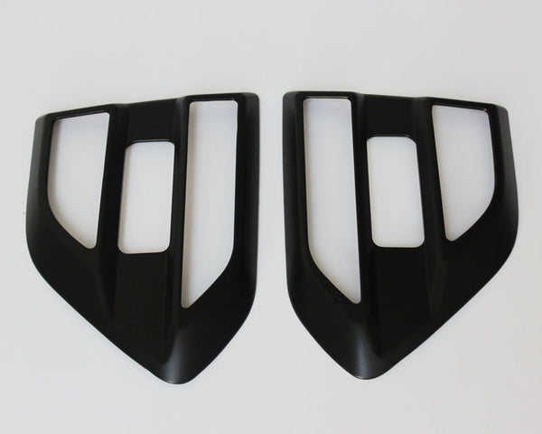 Two black, angular car air vent covers with rectangular openings positioned side by side on a white background.