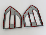 Two plastic frames, shaped like arrowheads, are placed side by side on a white background. Each frame is grey with red lining and features numbered notches along the edges.