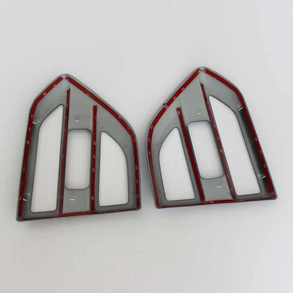 Two plastic frames, shaped like arrowheads, are placed side by side on a white background. Each frame is grey with red lining and features numbered notches along the edges.