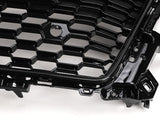 A black, honeycomb-patterned car grille with glossy finish, displayed at an angle on a plain white background.
