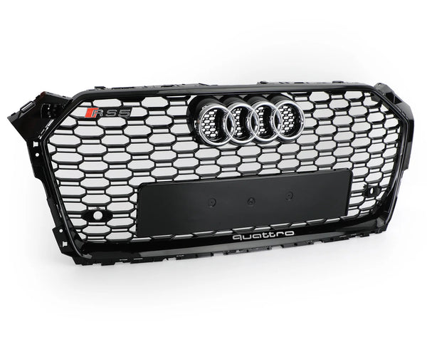 A black Audi car grille with a honeycomb pattern features a chrome Audi emblem, "RS5" badge, and the word "quattro" at the bottom, displayed against a plain white background.