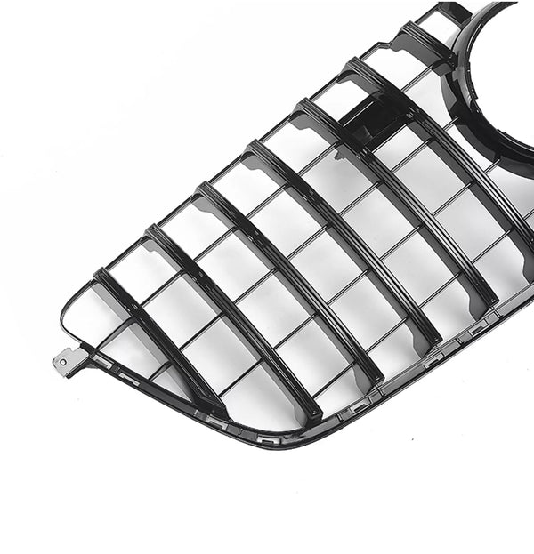 A glossy black car grille features horizontal slats and a circular opening, positioned against a plain white background.