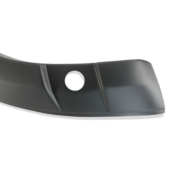 A black curved plastic car bumper cover with a circular hole, featuring angular lines, is set against a plain white background.