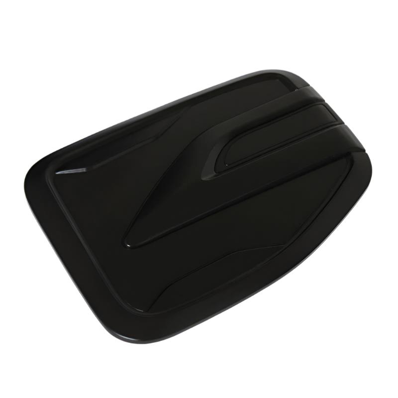 Rectangular black object with angled, aerodynamic grooves across its surface, resembling a vent cover. It rests on a flat white background.