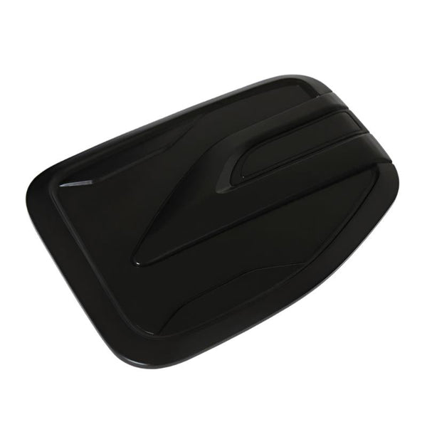 Rectangular black object with angled, aerodynamic grooves across its surface, resembling a vent cover. It rests on a flat white background.