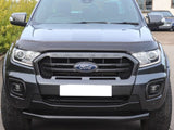A black Ford Ranger parked on a driveway, featuring a prominent grille with 