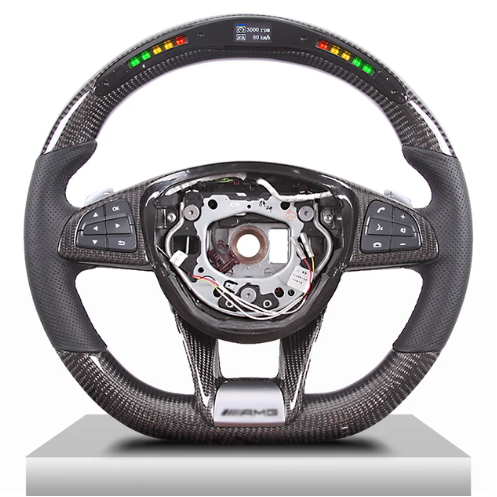 A carbon-fiber steering wheel features multifunction buttons on the sides and a digital display at the top. The center is missing, revealing internal mechanisms. Display text: "3000 RPM, 120 km/h."