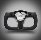 A U-shaped steering wheel features a central metal hub with button slots, contrasting against a gray gradient background. No text present.