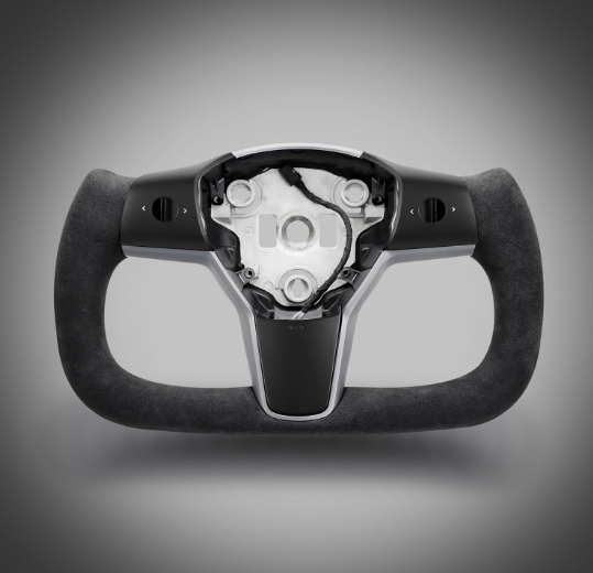 A futuristic, U-shaped car steering wheel with a sleek black finish and exposed mechanical components sits against a gradient gray background.