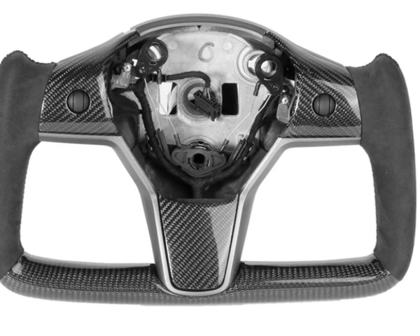 A carbon-fiber steering wheel frame, without a central panel or buttons, rests on a plain white background, showing sleek ergonomic grips and precise craftsmanship.