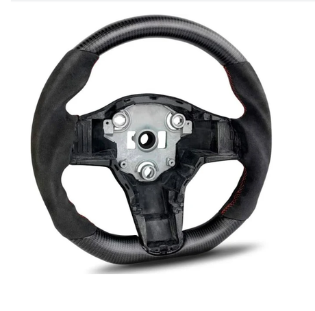 A carbon fiber steering wheel with a central metal hub is positioned upright. It features red stitching and lacks controls, set against a plain white background.