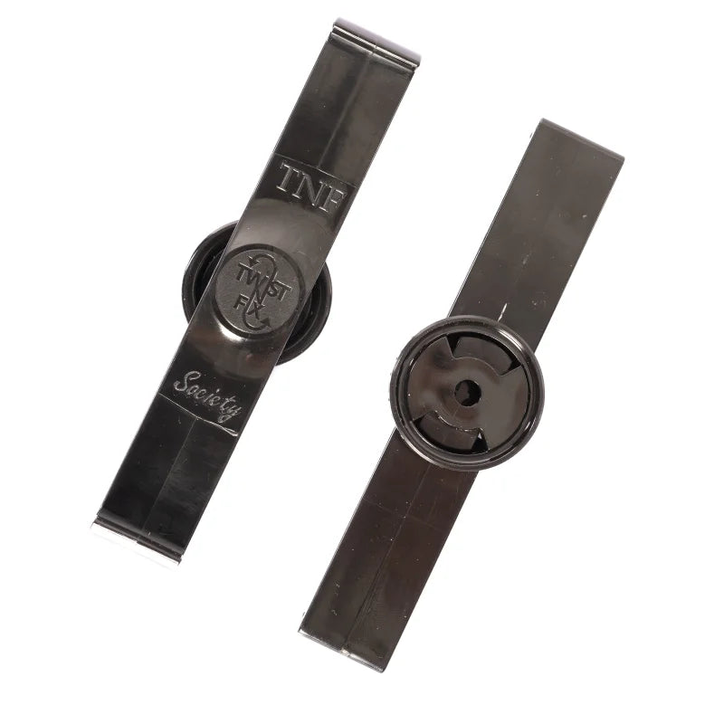 Two rectangular black tags with circular centers, used for security. One tag has text: "TNF," "TWIST FA," and "Society." Placed on a plain white background.