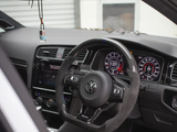 Steering wheel with a Volkswagen logo is centered, showing dashboard indicators at 126.0 km/h. Digital displays and controls within a car interior. An air freshener hangs from rearview mirror.