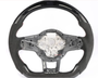 Steering wheel without the central cover, featuring carbon fiber details and exposed wires, set against a plain white background.
