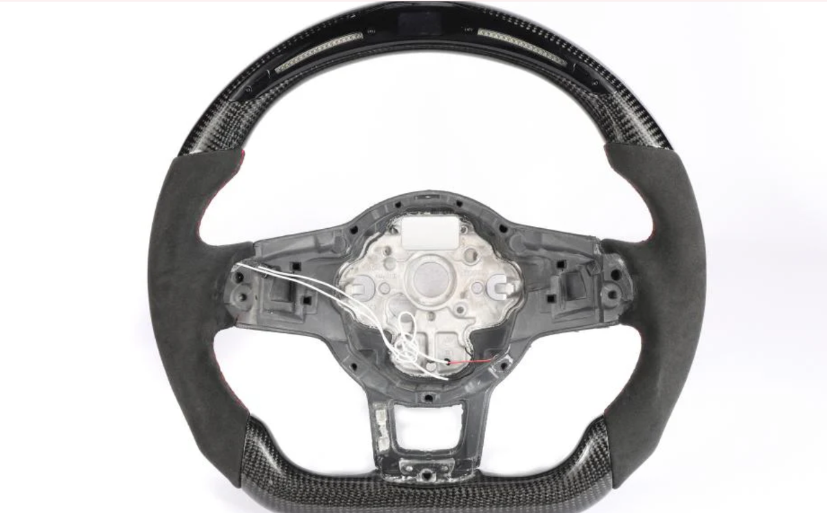 Steering wheel without the central cover, featuring carbon fiber details and exposed wires, set against a plain white background.