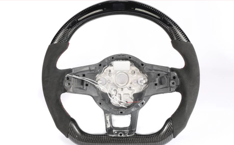 Steering wheel without the central cover, featuring carbon fiber details and exposed wires, set against a plain white background.