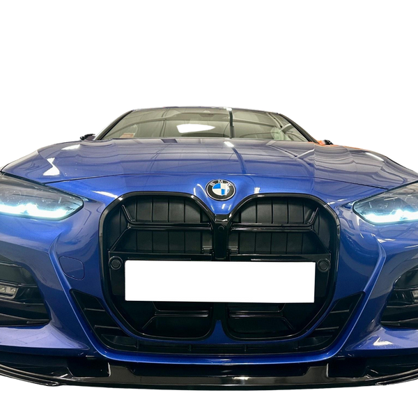 A blue car with illuminated headlights is facing forward, showcasing its prominent black grille and a visible logo, set against a black background.