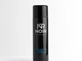 A sleek black aerosol can stands upright, labeled 