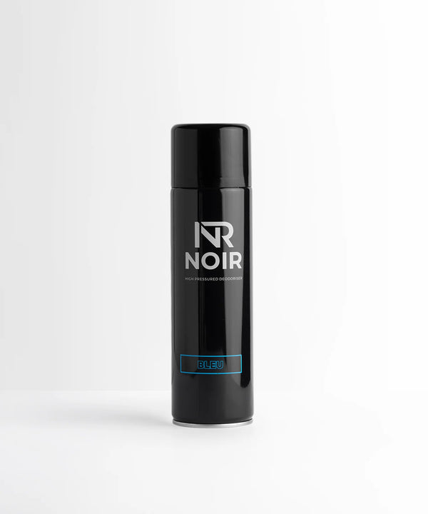 A sleek black aerosol can stands upright, labeled "NR NOIR" and "HIGH PRESSURED DEODORISER" with a "BLEU" section in blue. It's set against a plain white background.