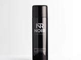 A black aerosol can labeled 