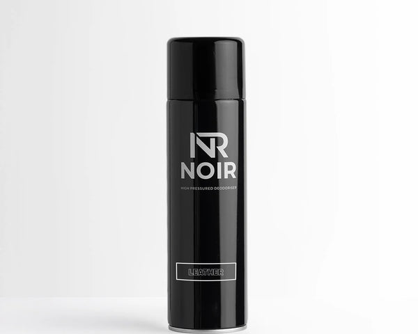 A black can labeled "NR NOIR" with "HIGH PRESSURED DEODORISER" and "LEATHER." It stands on a plain white surface against a light gray background, conveying a minimalist aesthetic.