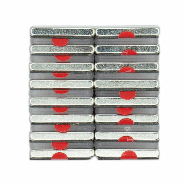 Rectangular metal tins are stacked in a 4x4 grid, each featuring a red semi-circle on the side, set against a plain white background.
