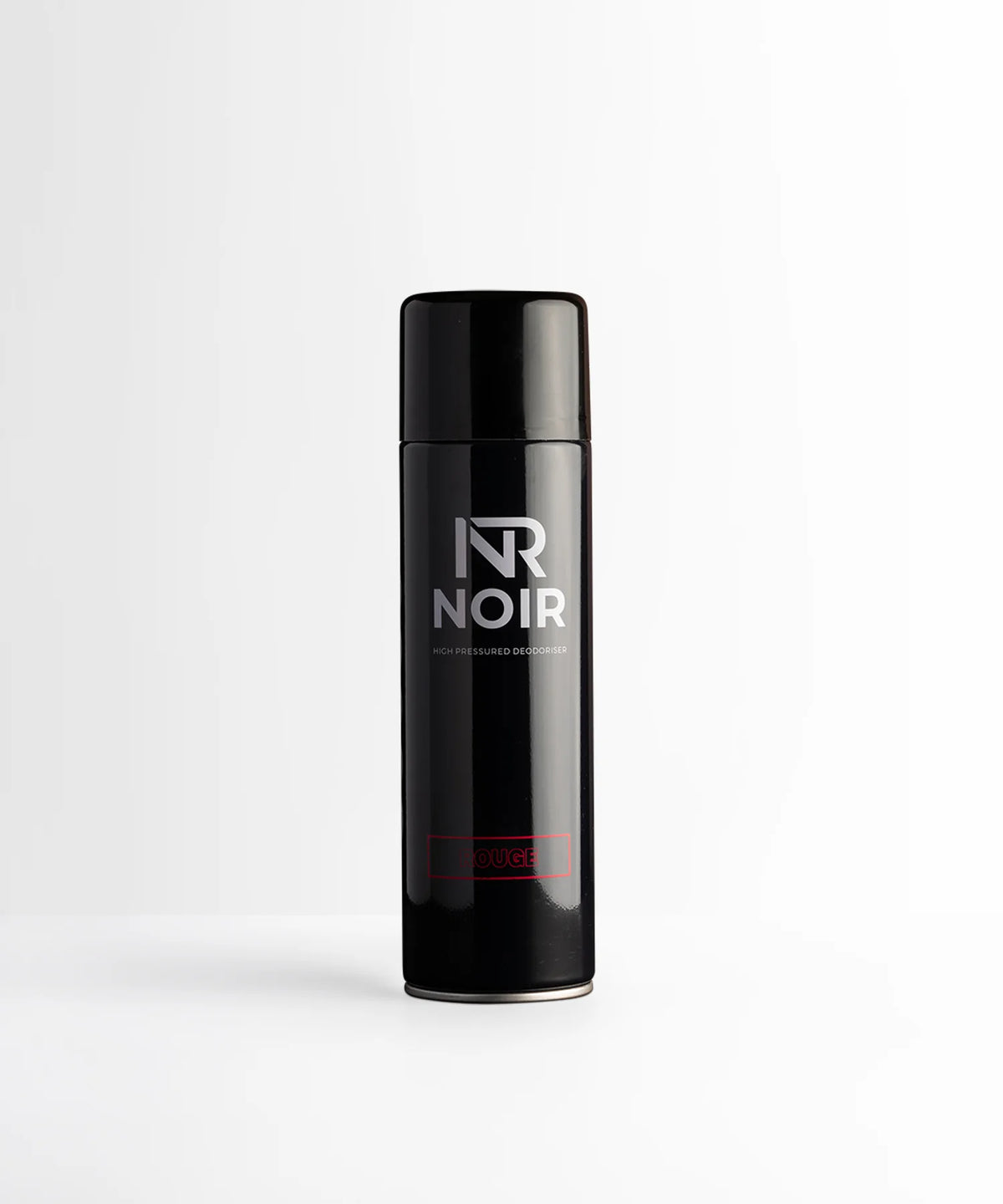 A black aerosol can labeled “NR NOIR” and “HIGH PRESSURED DEODORISER” stands upright on a plain white surface. The word “ROUGE” is in red near the base.