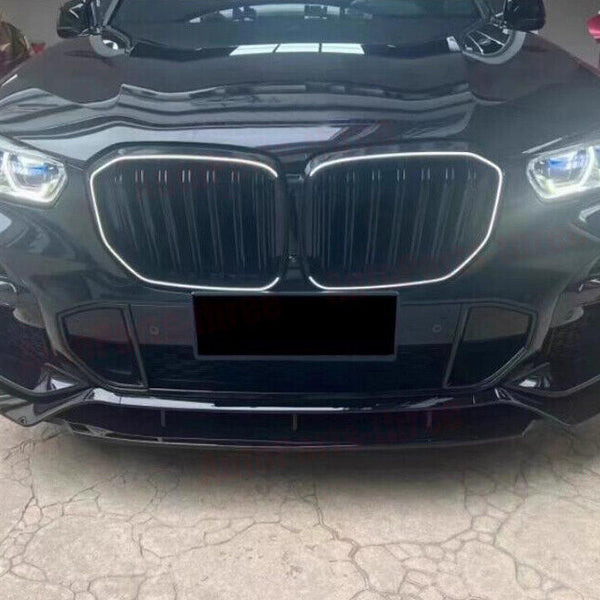 A black car's front view shows a large grille and illuminated headlights, parked on a concrete surface. Red ribbons in the background suggest a celebratory or gifting context.