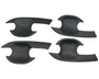 Four black, curved, plastic car door handle covers are positioned symmetrically on a plain background. They have an ergonomic design with cutouts for easy installation.