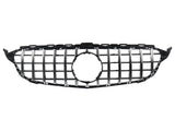 A black and silver car grille features vertical slats with a circular emblem cutout in the center, set against a plain white background.