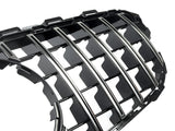 A shiny black car grille with vertical chrome slats, designed for vehicle front-end placement, lies against a white background, emphasizing its sleek, reflective surfaces and intricate detailing.