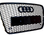 A black, honeycomb-patterned car grille featuring four linked rings at the top, with a rectangular placeholder for a license plate, set against a white background.