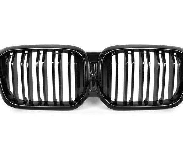 A black, dual-oval car grille with vertical slats, centrally connected, lies against a plain white background, indicating an automotive part typically used for front vehicle aesthetics and ventilation.