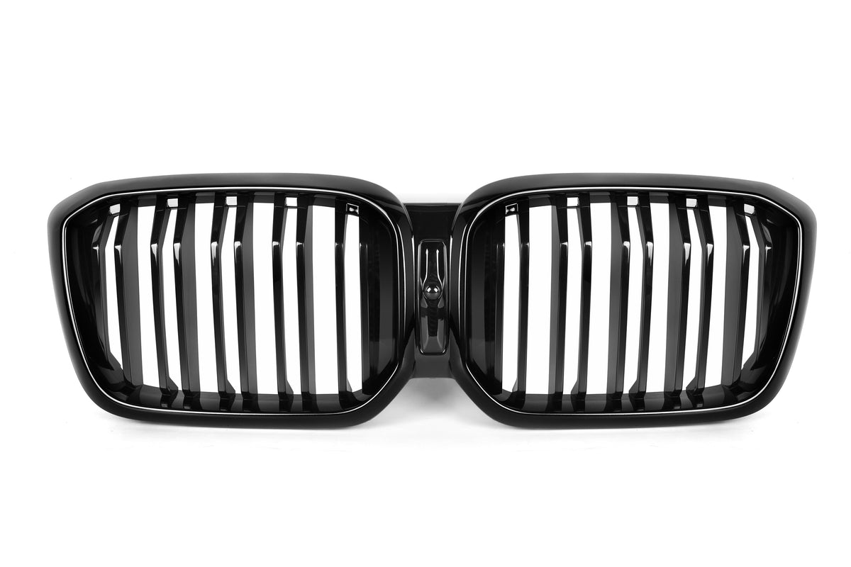 A black, dual-oval car grille with vertical slats, centrally connected, lies against a plain white background, indicating an automotive part typically used for front vehicle aesthetics and ventilation.