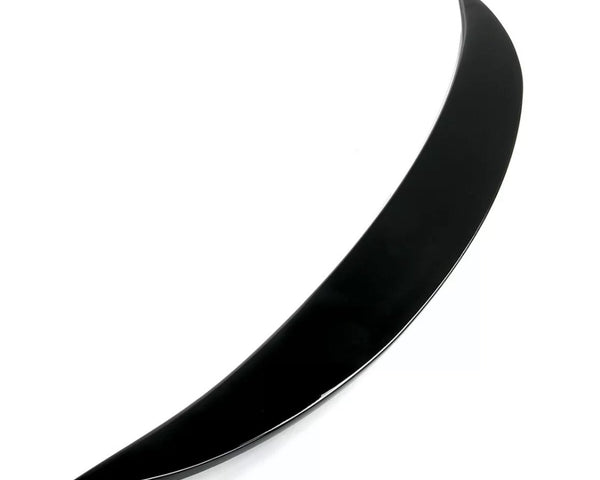 A sleek, black, curved object rests against a white background, resembling a crescent or boomerang shape, suggesting potential for aerodynamic purposes or decorative design.