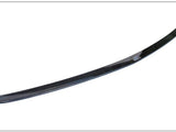 A sleek, curved carbon fiber spoiler lies on a plain white background. The spoiler's glossy surface reflects light, highlighting its aerodynamic design.