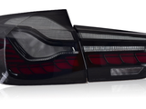 A sleek car taillight, featuring bold red and clear segments, is positioned against a white studio background.