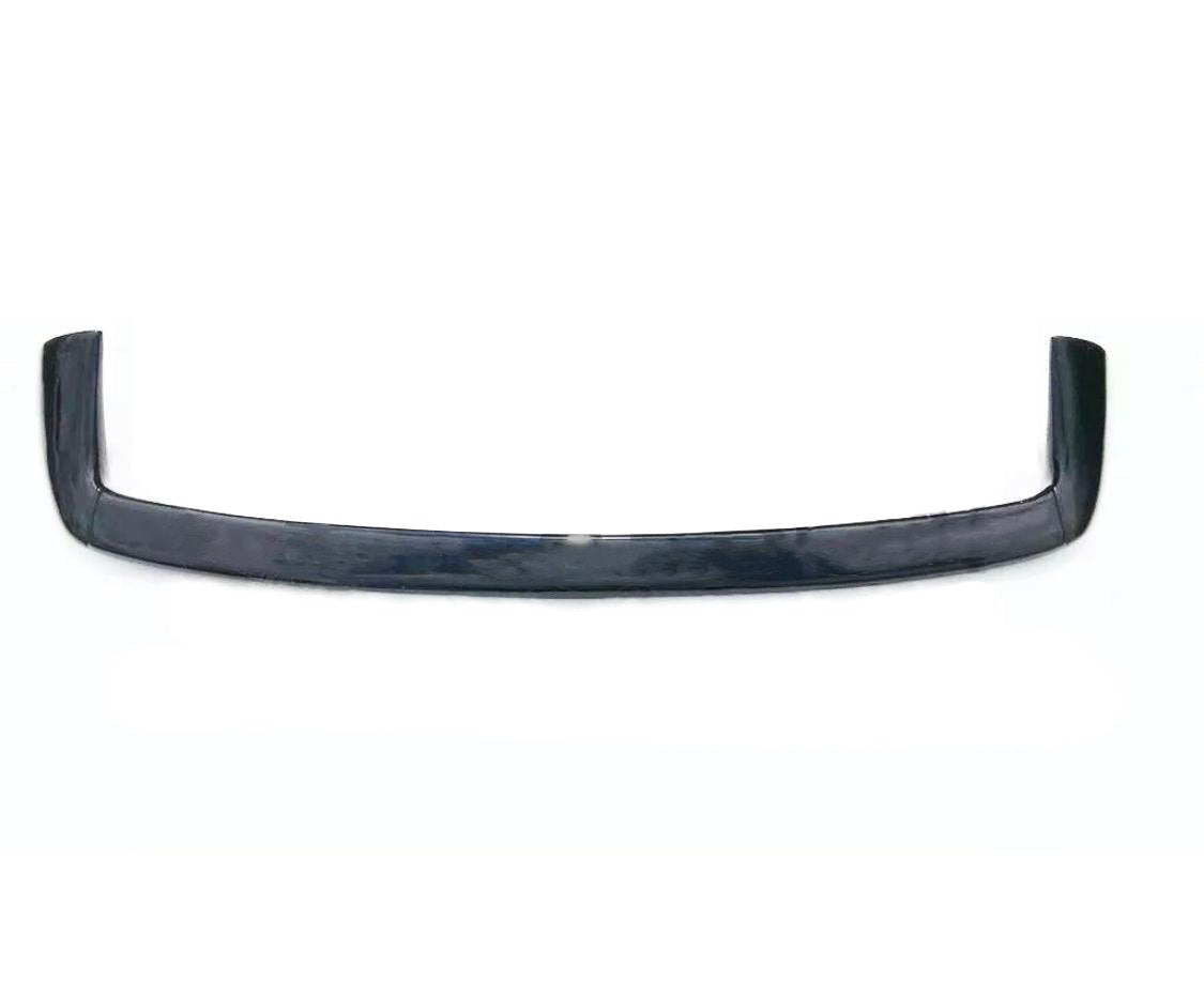 A sleek, black car spoiler with an upward curve lies on a white background, highlighting its aerodynamic design features.