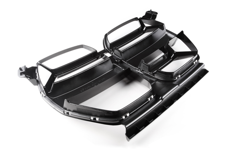 A black plastic automotive grille with angular design elements sits on a white background, featuring rectangular openings and intricate detailing, highlighting its structural and aesthetic functions.